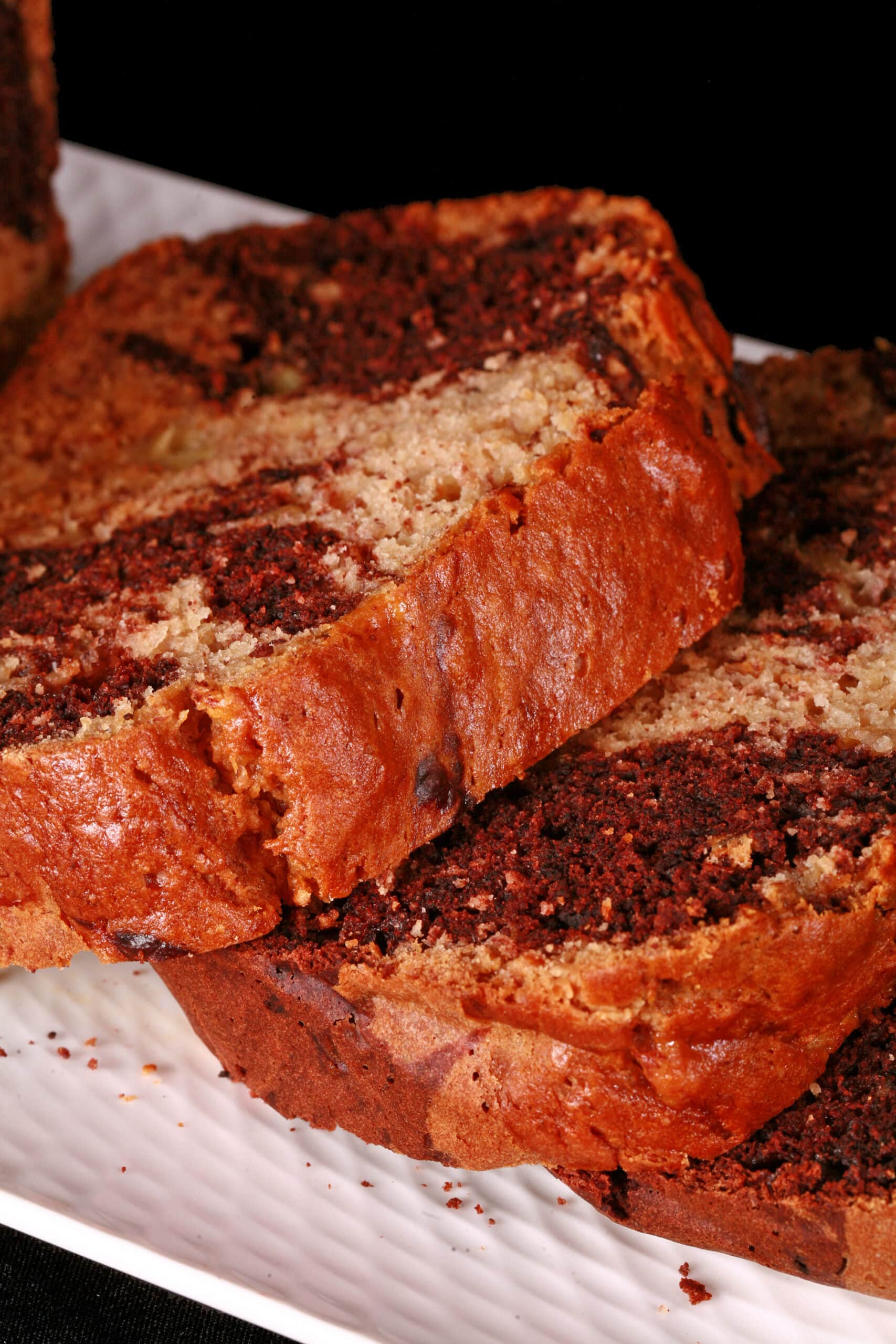 A sliced loaf of peanut butter and chocolate marbled banana bread.