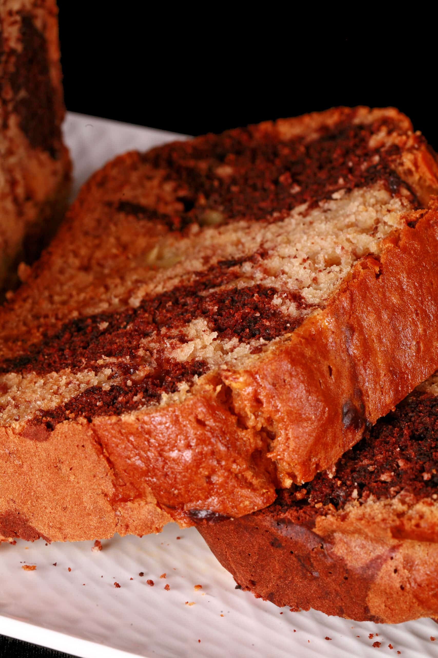 A sliced loaf of peanut butter and chocolate marbled banana bread.