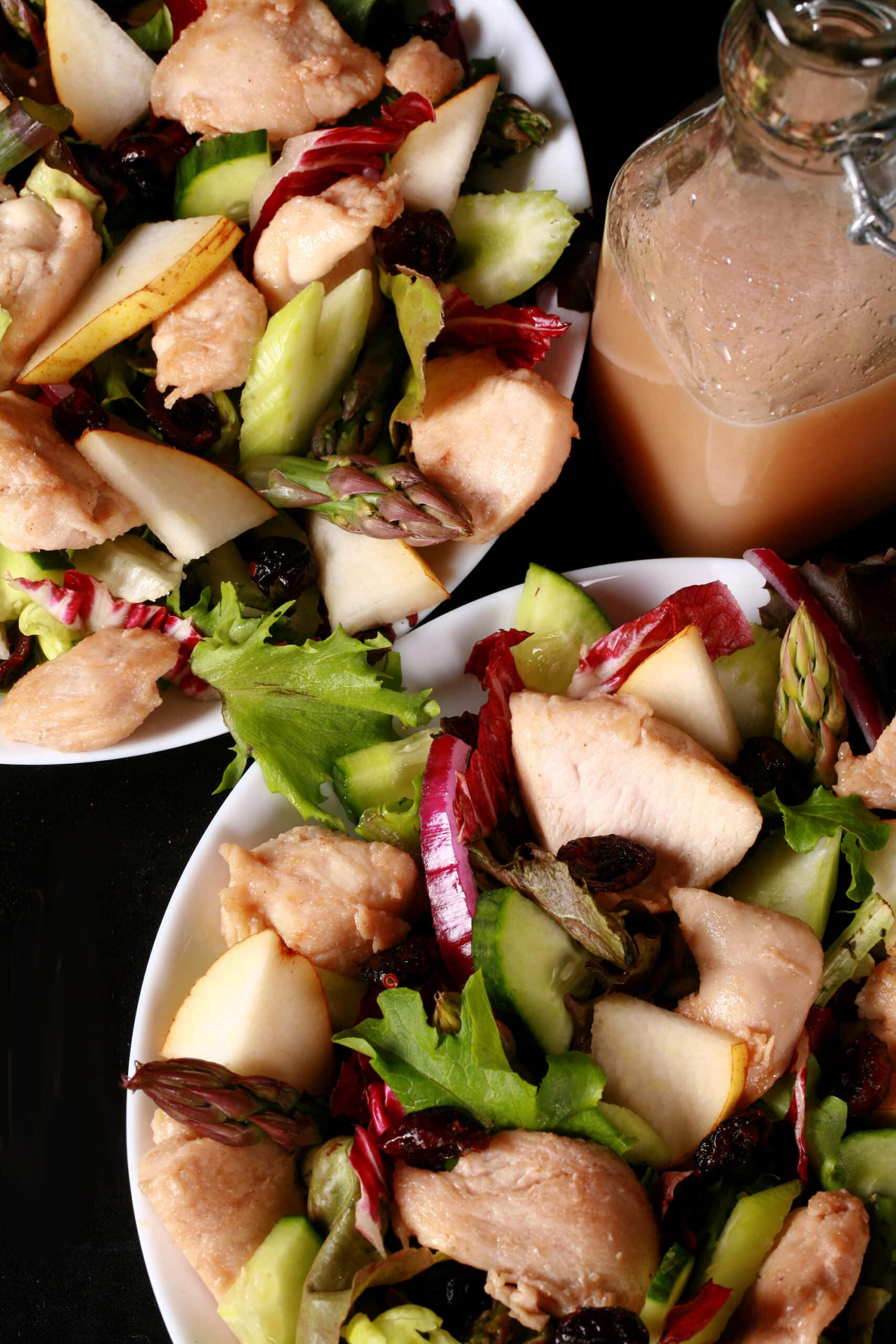 2 bowls of cranberry pear chicken salad and a bottle of cranberry-pear white balsamic vinaigrette.