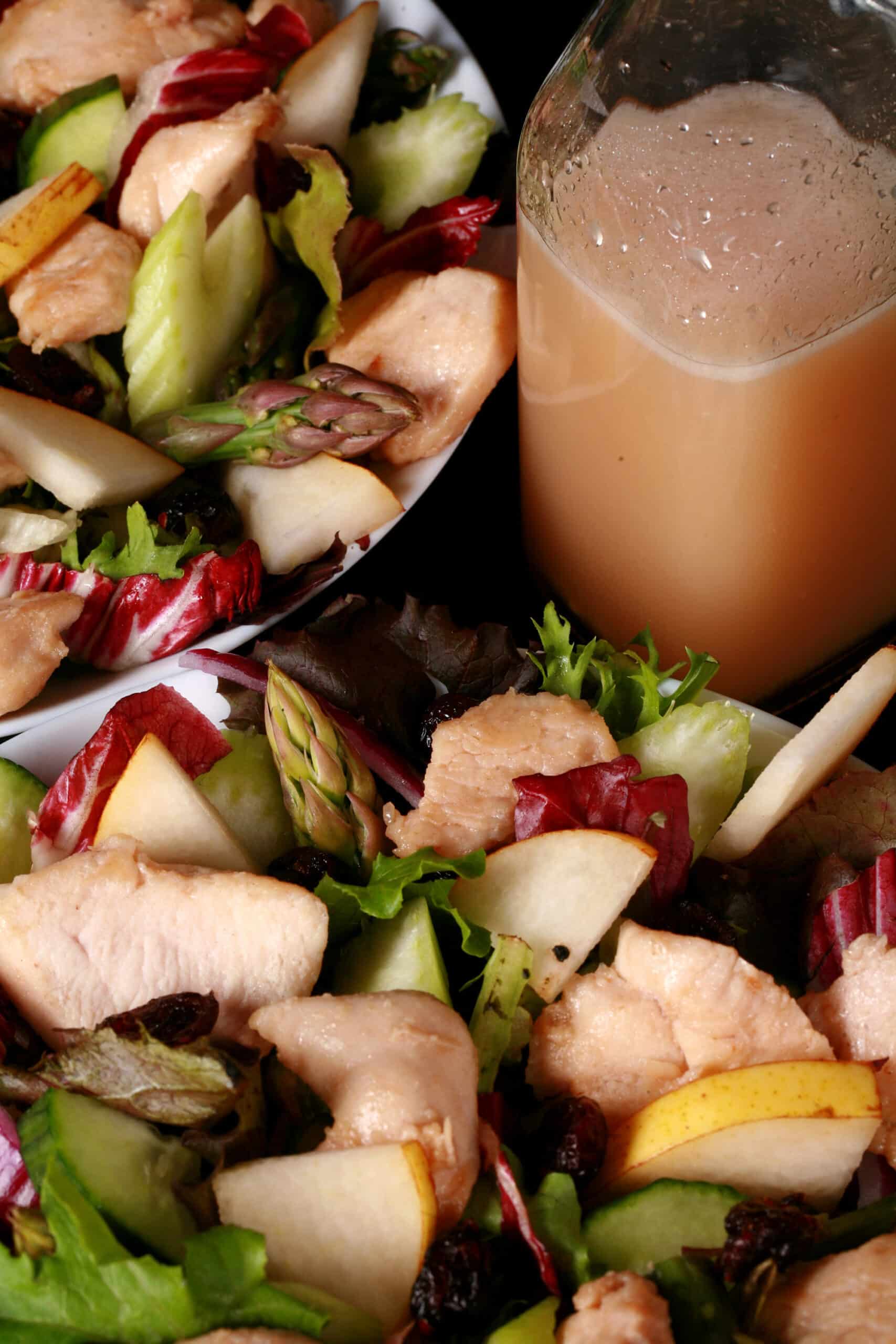 2 bowls of cranberry pear chicken salad and a bottle of cranberry-pear white balsamic vinaigrette.