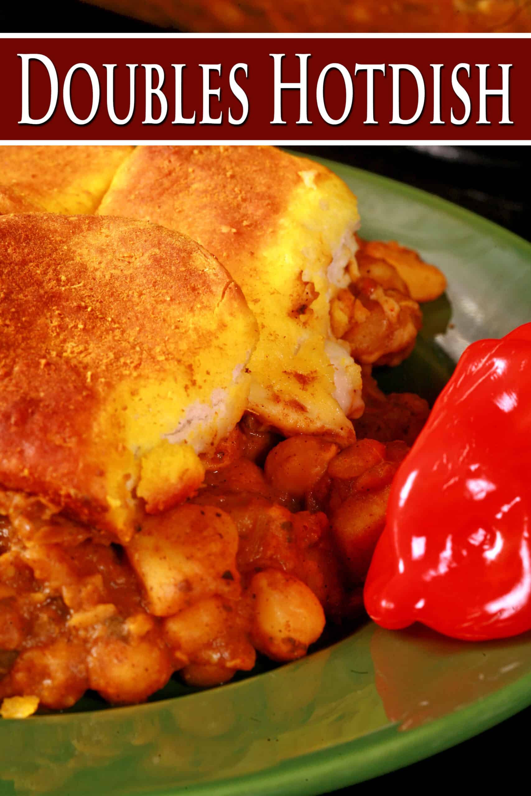 A serving of doubles hotdish - a trinidadian inspired casserole with a spiced chickpea and potato filling, topped with spiced butter brushed biscuits.