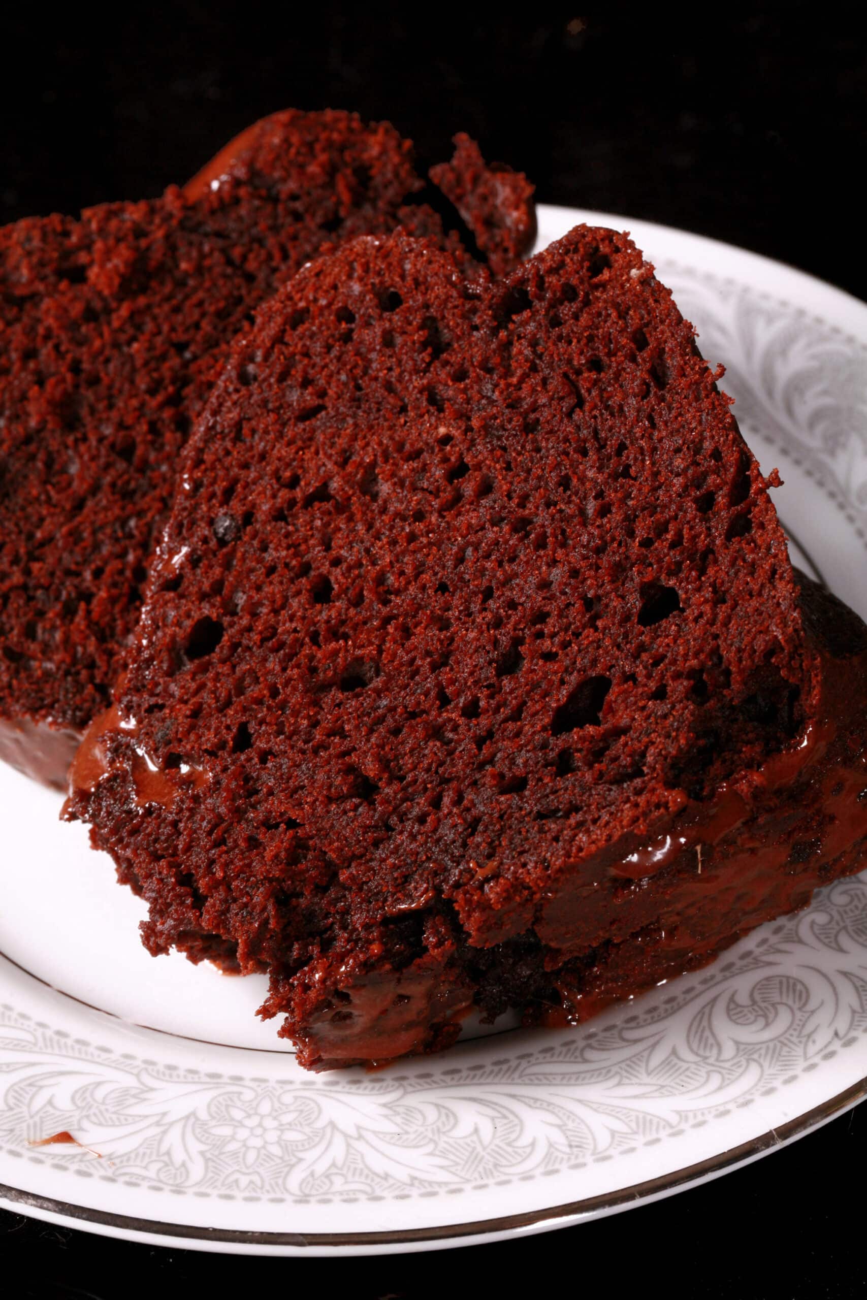 2 slices of homemade chocolate cake from a mix, on a plate.