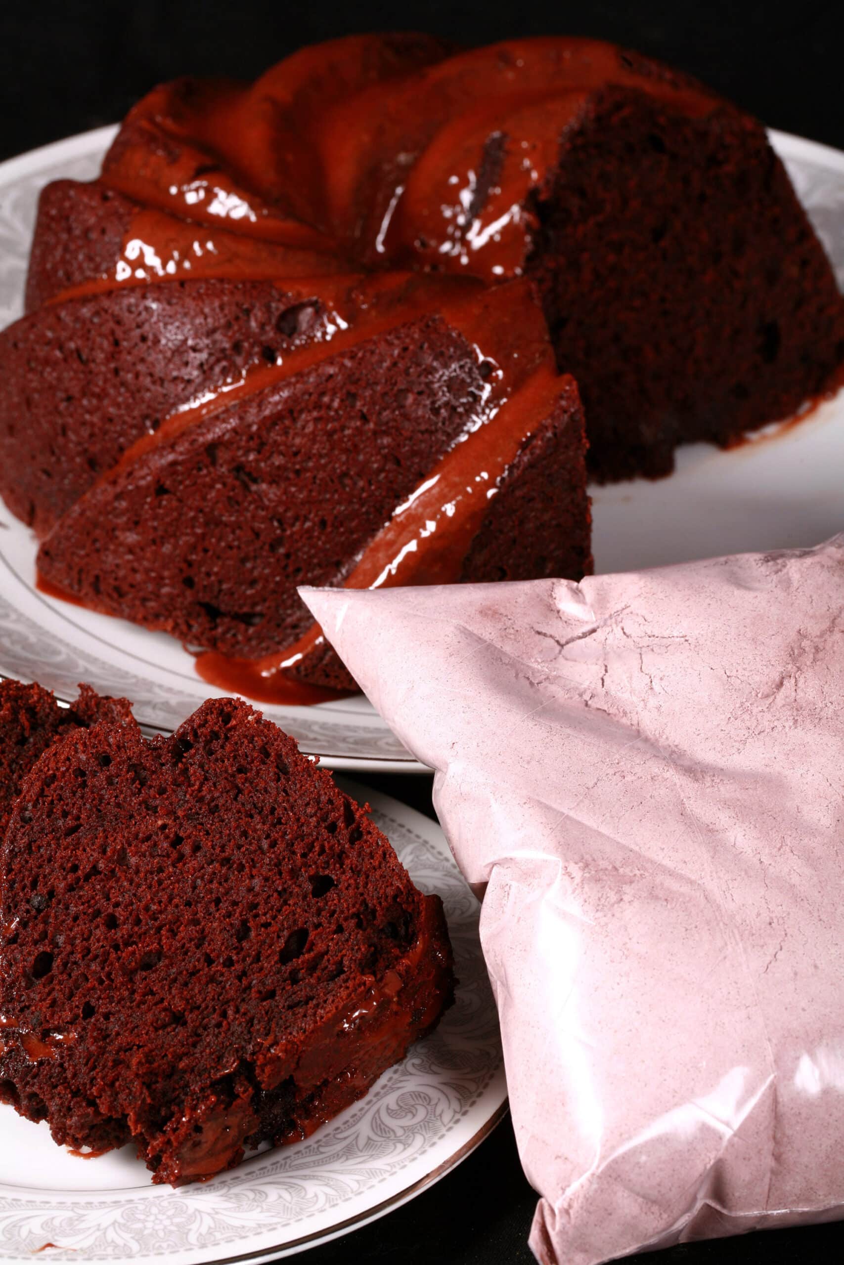 A chocolate bundt cake and a bag of homemade chocolate cake mix.