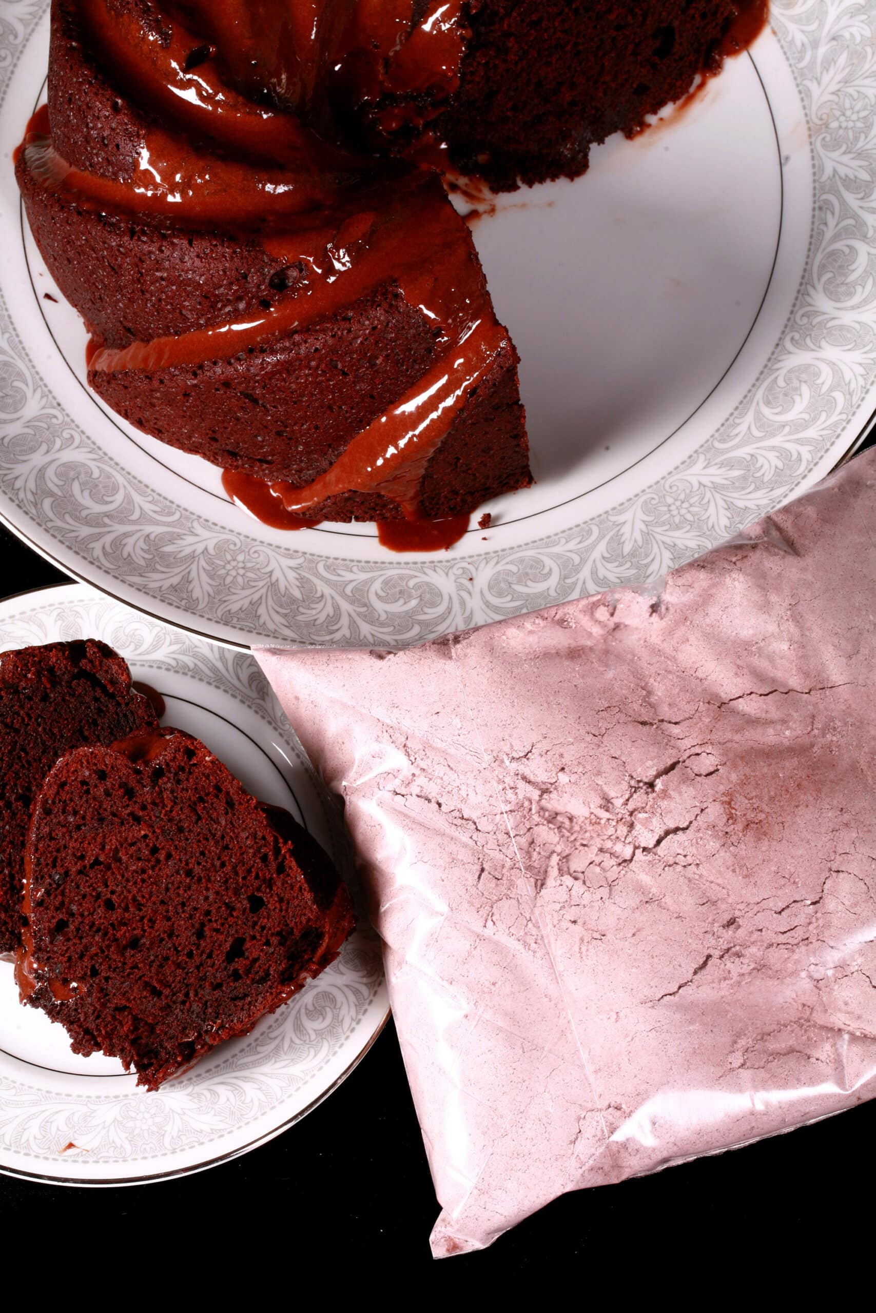A chocolate bundt cake and a bag of homemade chocolate cake mix.