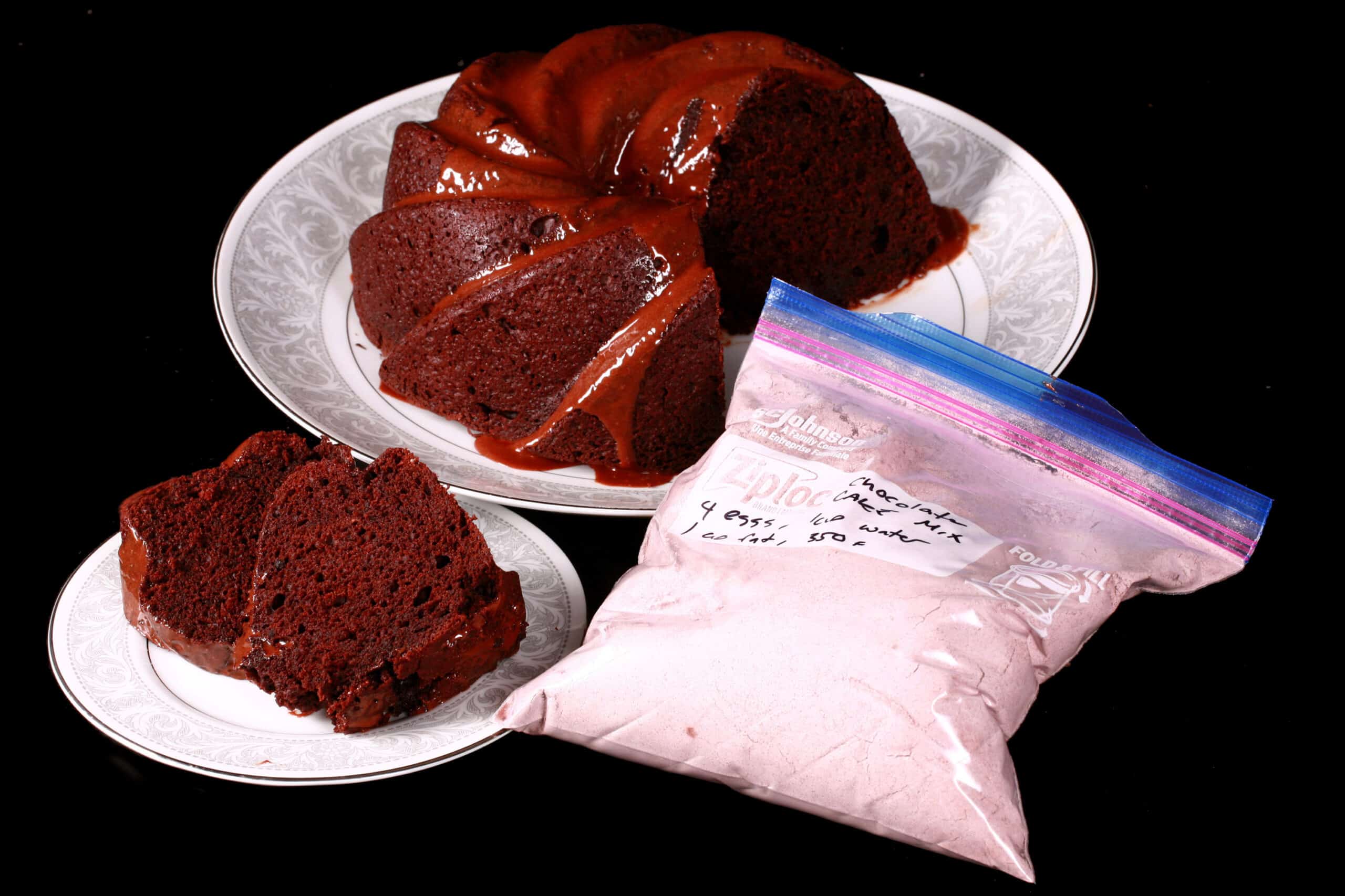 A chocolate bundt cake and a bag of homemade cake mix.