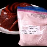 A chocolate bundt cake and a bag of homemade chocolate cake mix.
