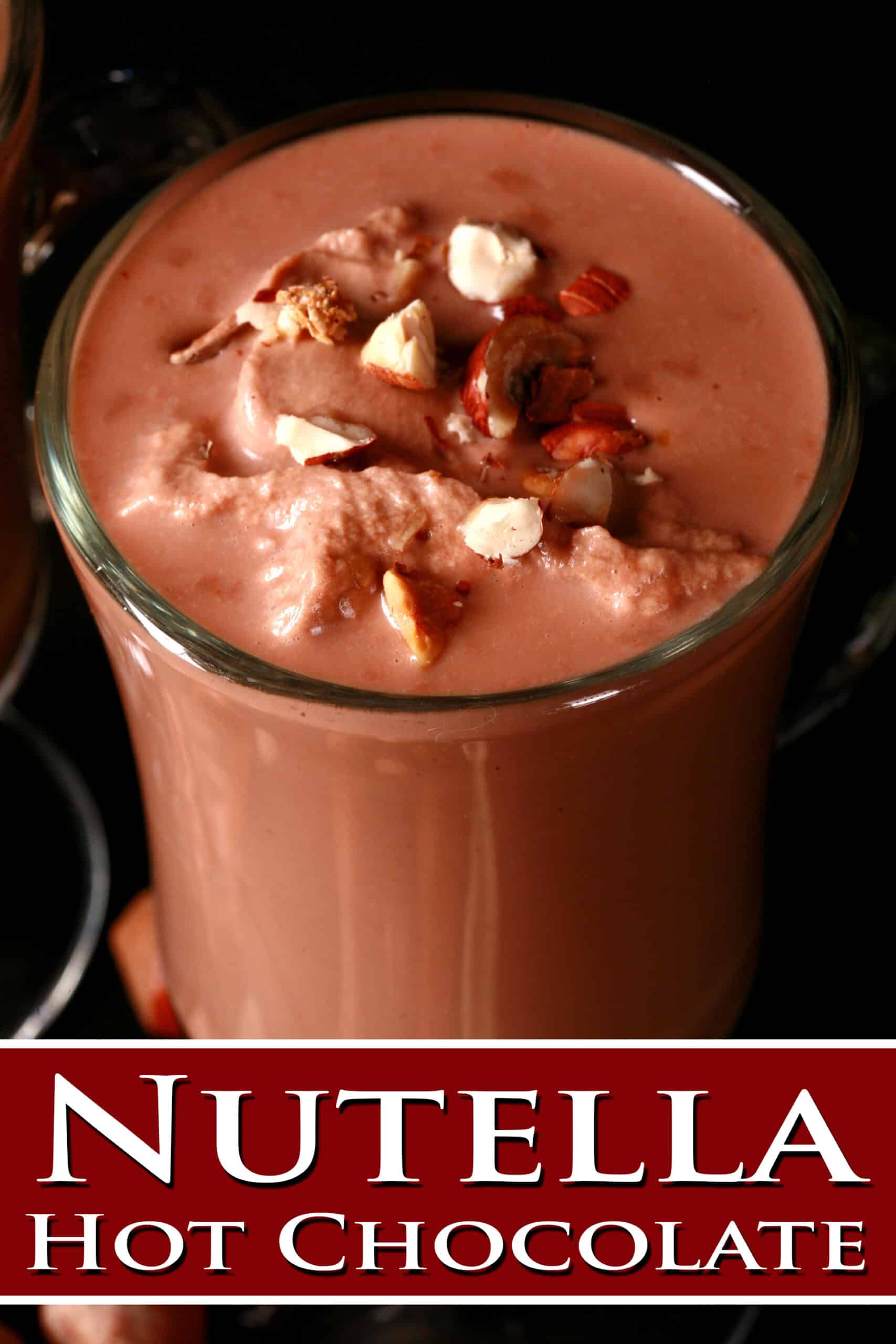 2 glass mugs of nutella hot cocoa, topped with nutella whipped cream and chopped hazelnuts.  Overlaid text says nutella Hot chocolate.