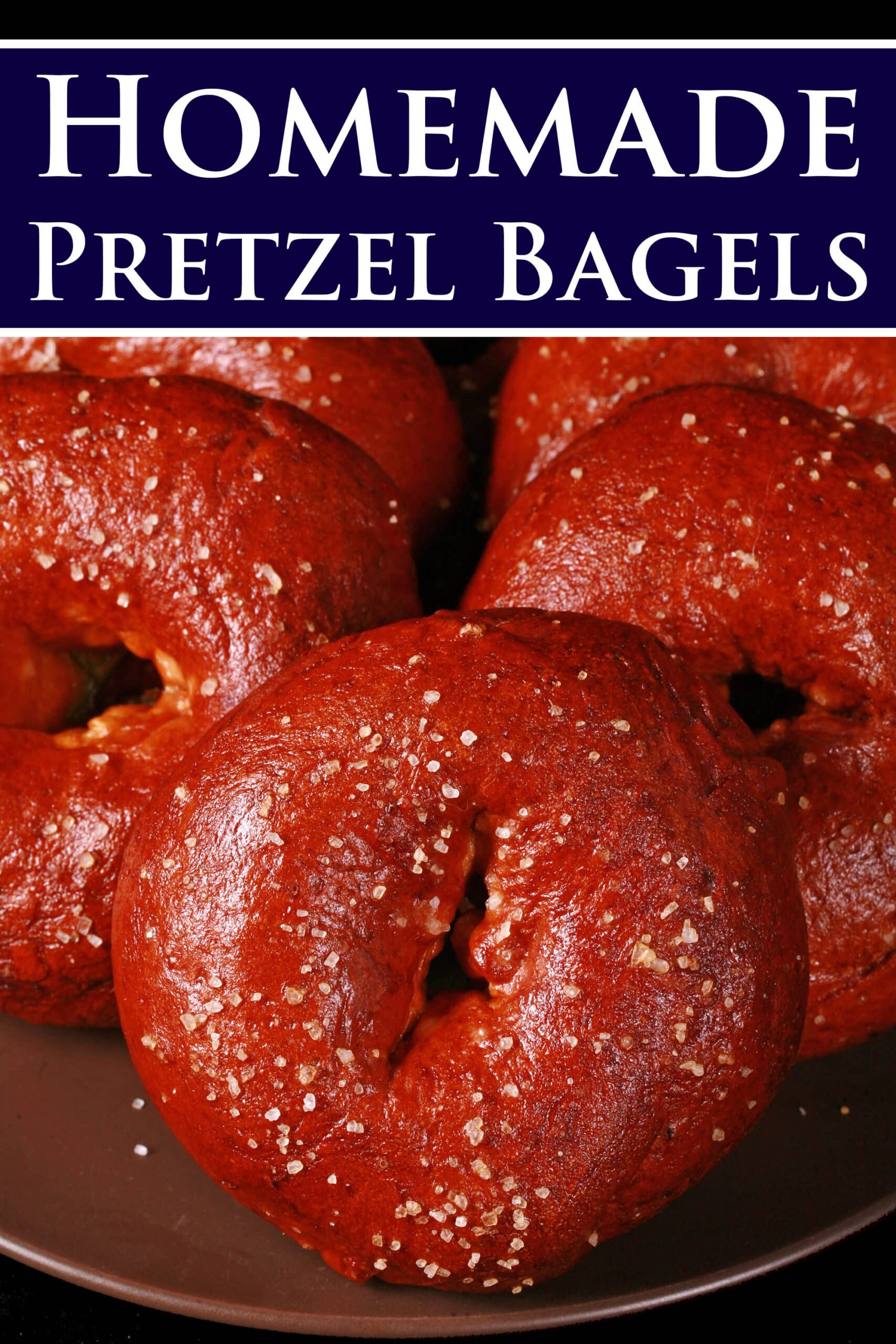 6 dark, reddish brown bagels topped with salt, Overlaid text says pretzel bagels.