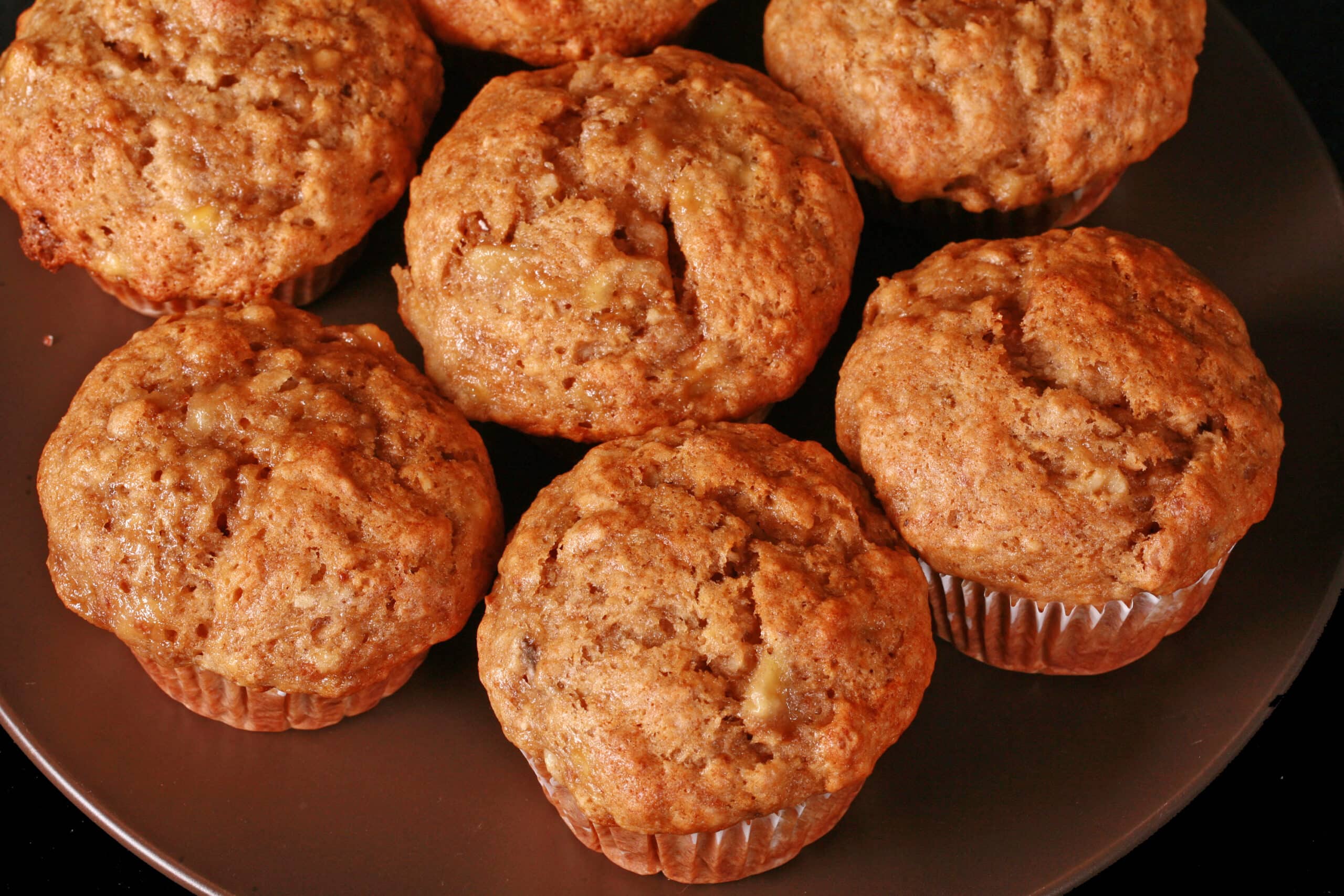 A plate of moist and fluffy egg free banana muffins.