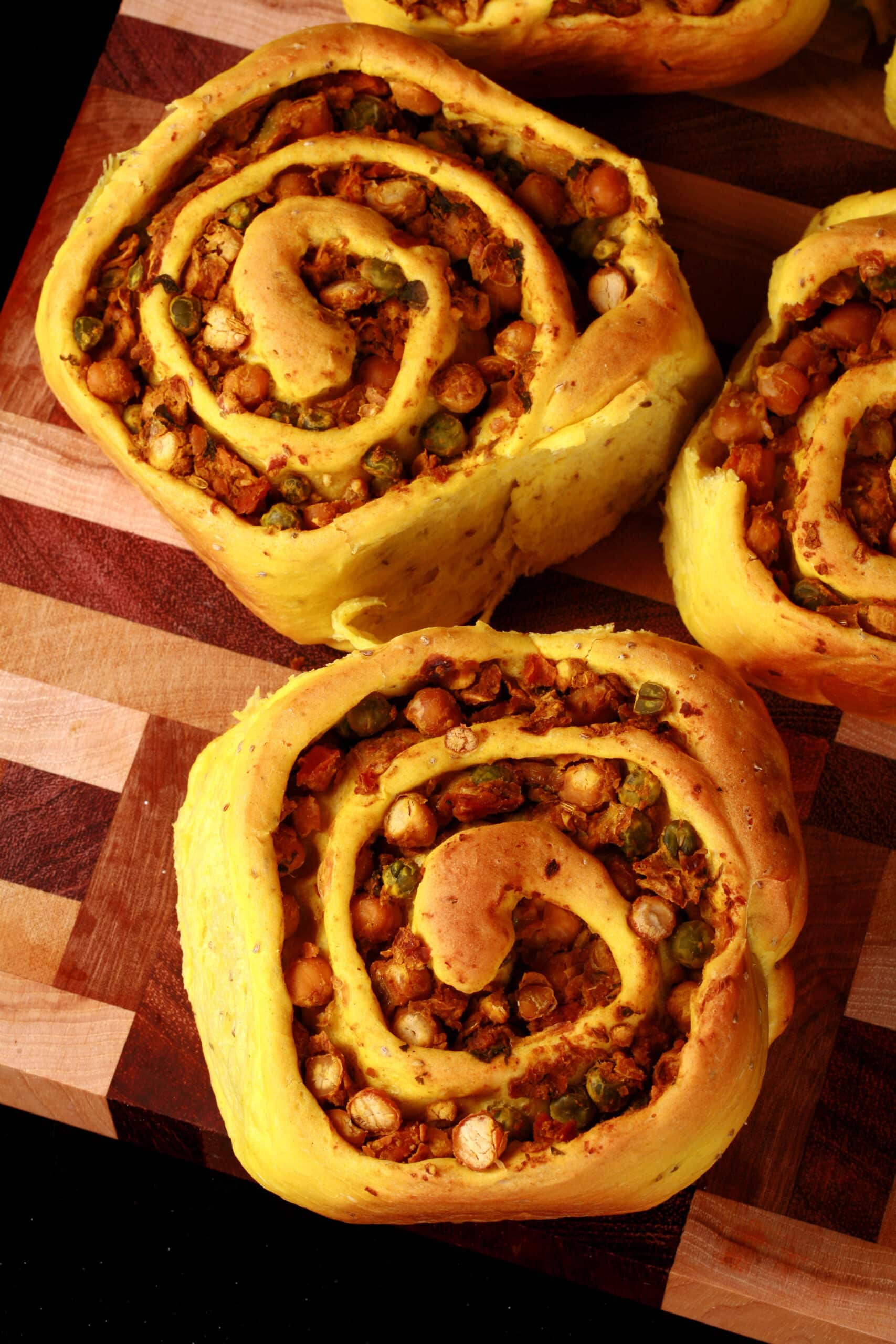 Several Samosa Rolls - A spiced dough rolled around a chickpea samosa filling, cinnamon roll style.