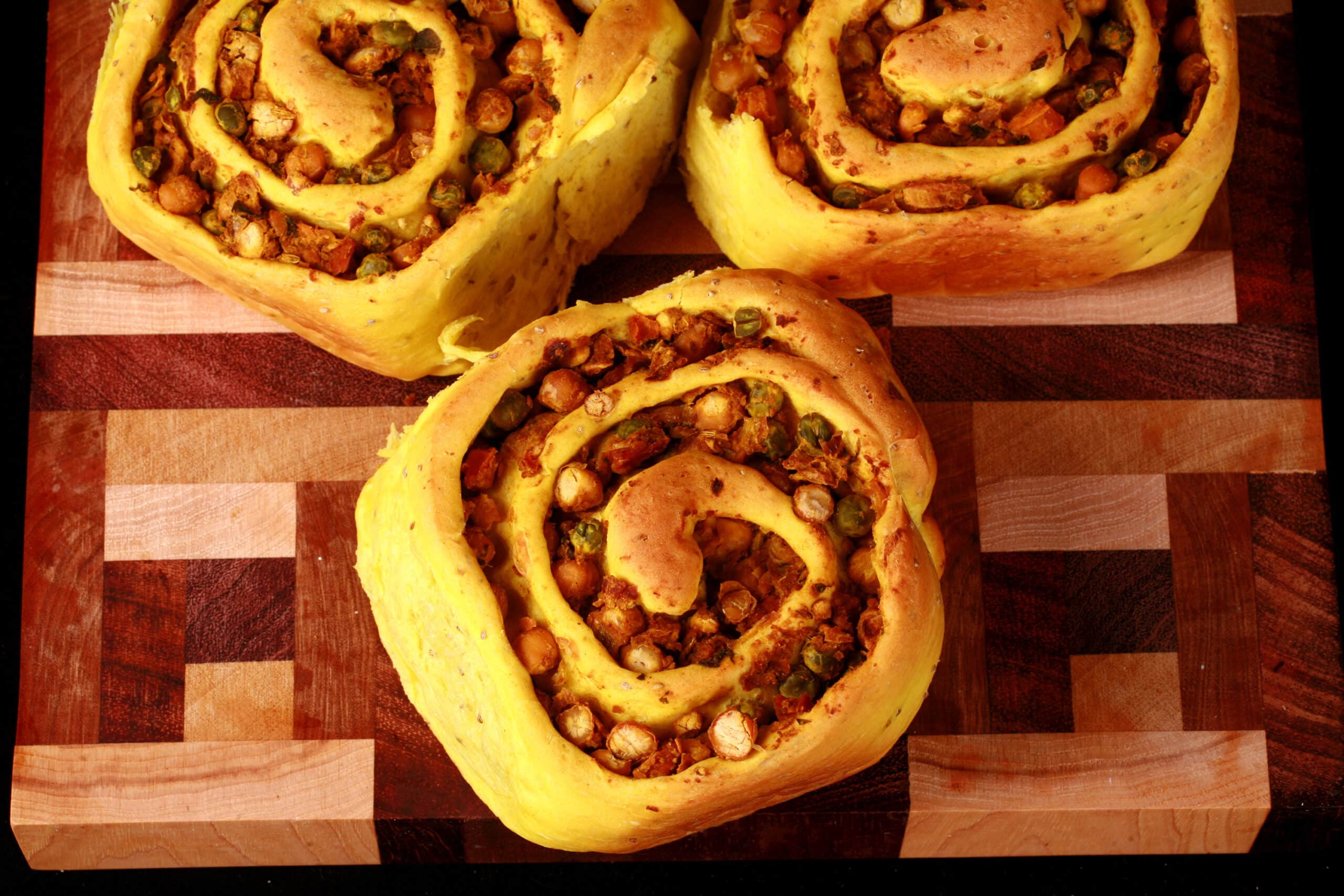 Several Samosa Buns - A spiced dough rolled around a chickpea samosa filling, cinnamon roll style.