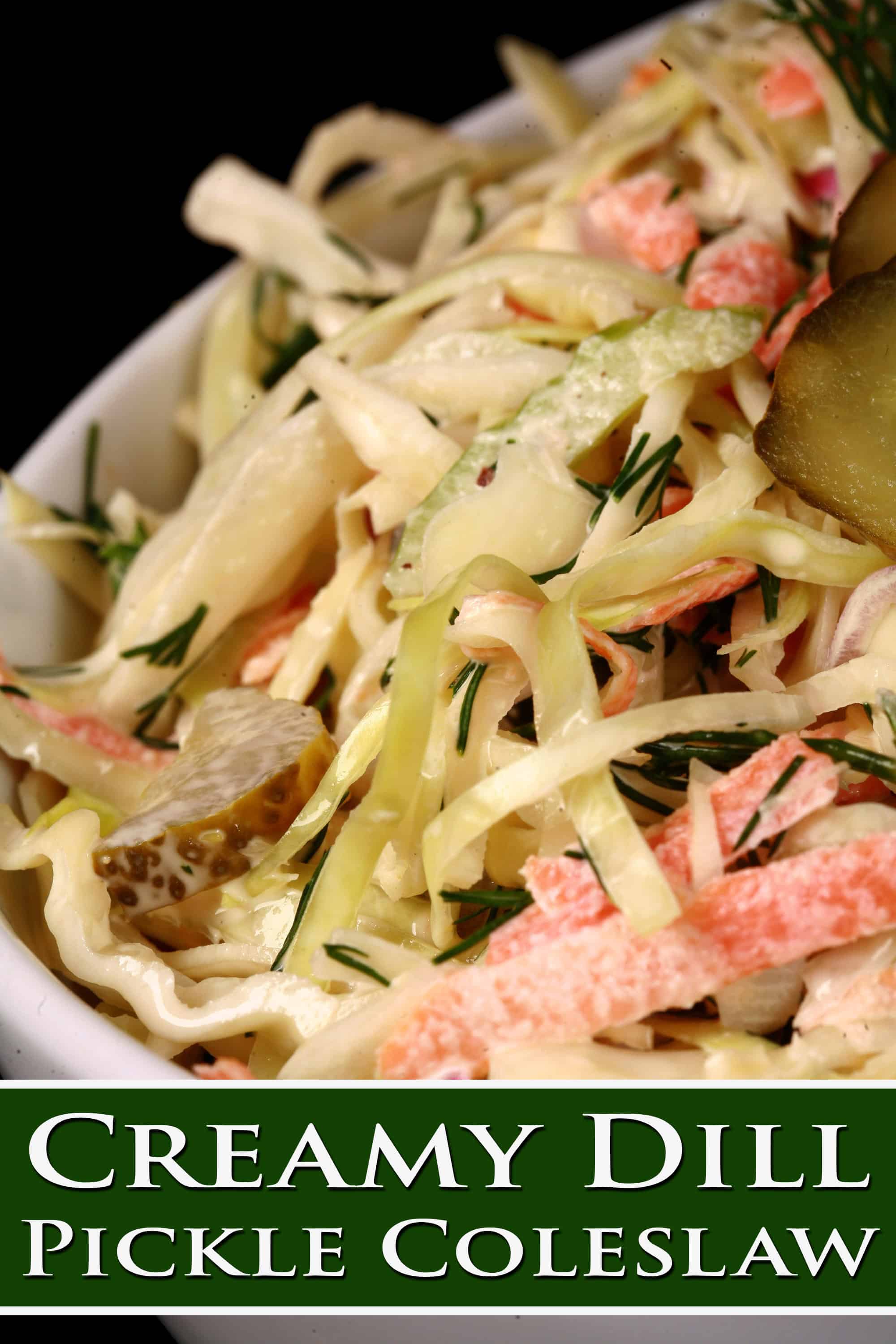 A bowl of creamy coleslaw with cabbage, carrots, red onions, pickles, and more. Overlaid text says creamy dill pickle coleslaw.
