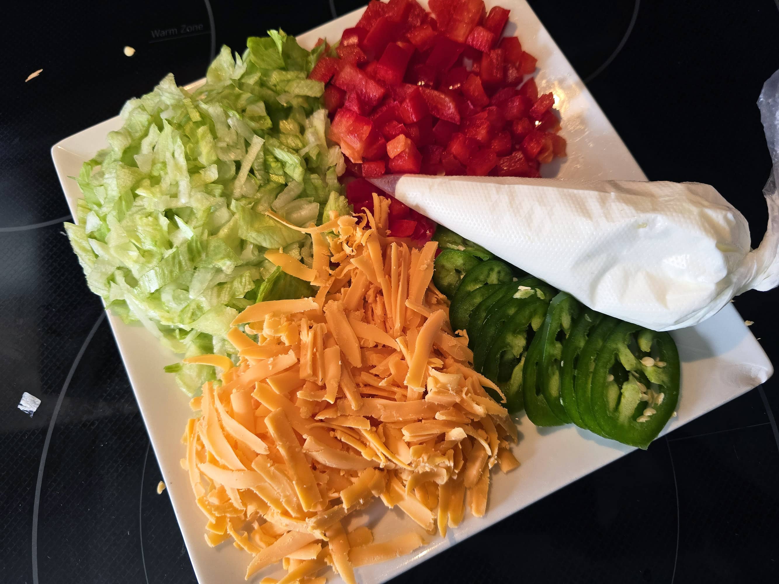 A plate with prepared taco toppings.