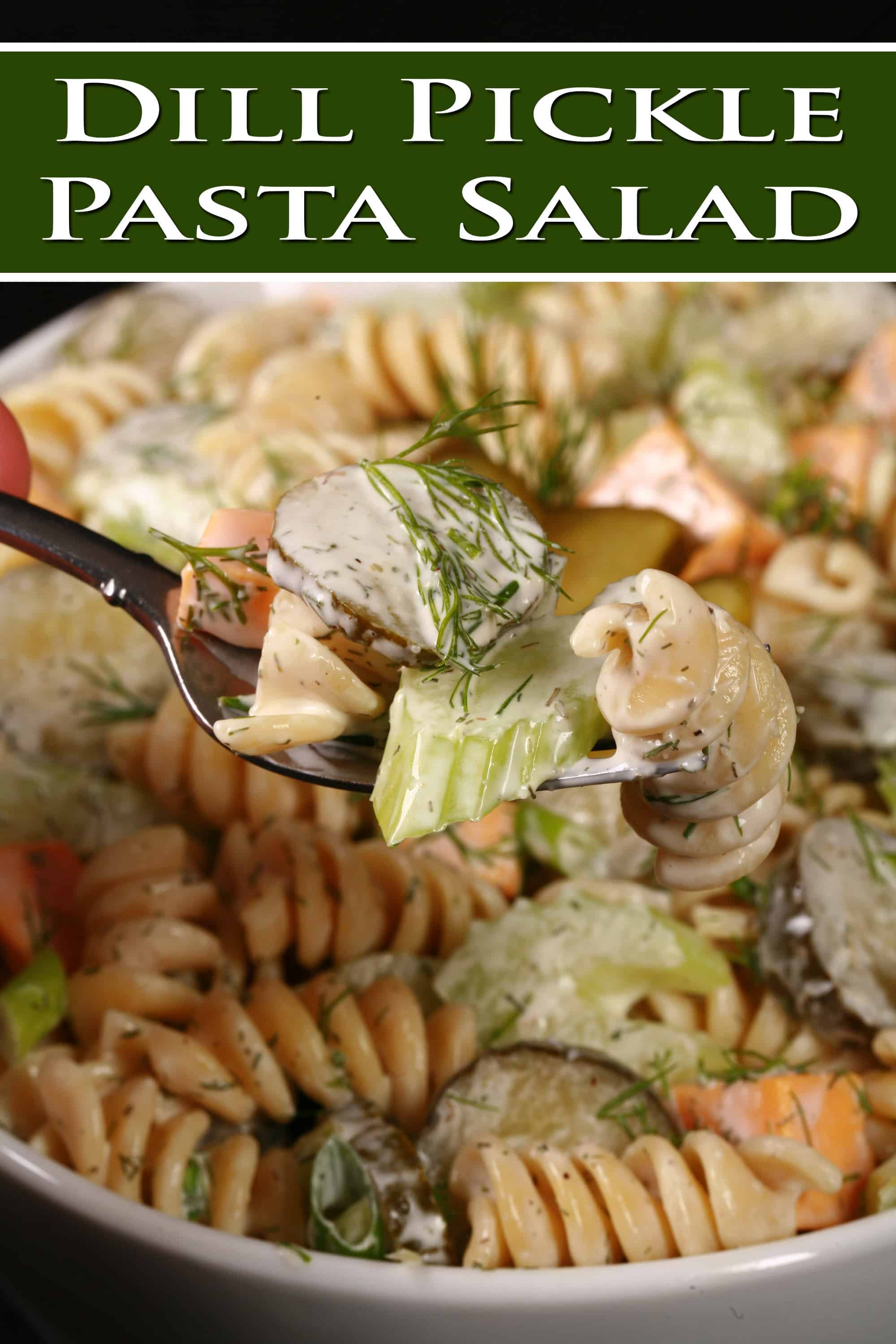 A bowl of dill pickle macaroni salad, with slices of pickles, green onion, and celery, fresh dill, and cubes of cheese in a creamy sauce. Overlaid text says dill pickle pasta salad.