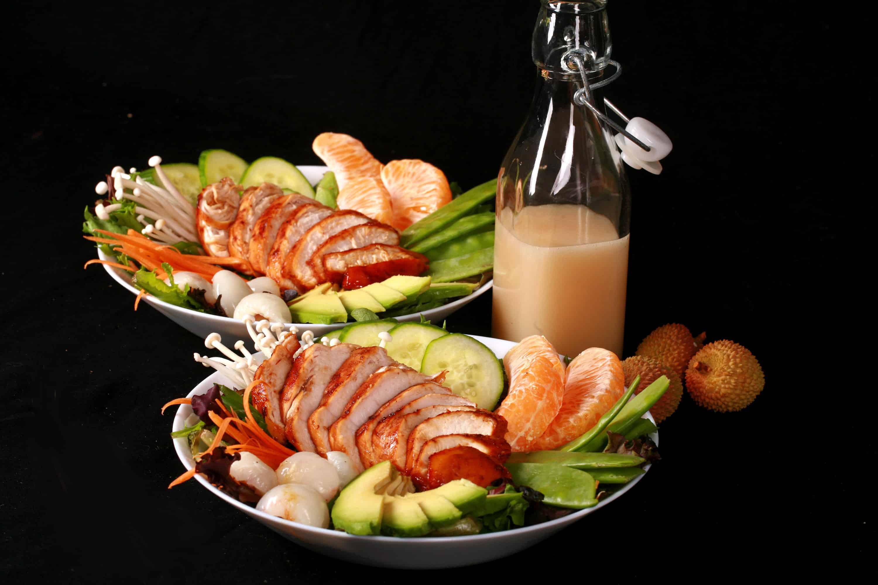 2 Asian chicken salad bowls with lychee vinaigrette.