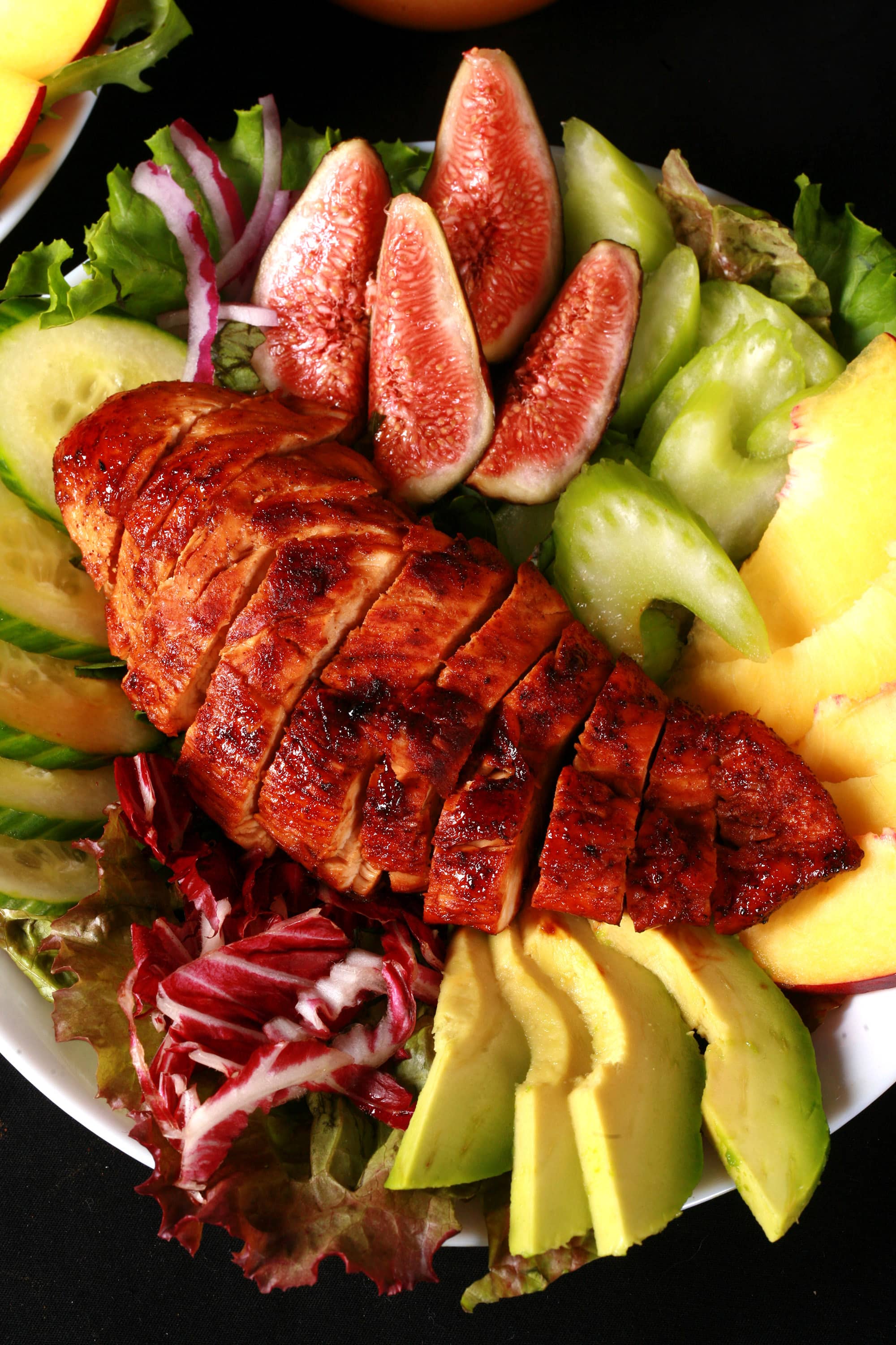 2 summer salads with peaches, figs, avocado, vegetables, and white peach balsamic vinegar glazed chicken breast.