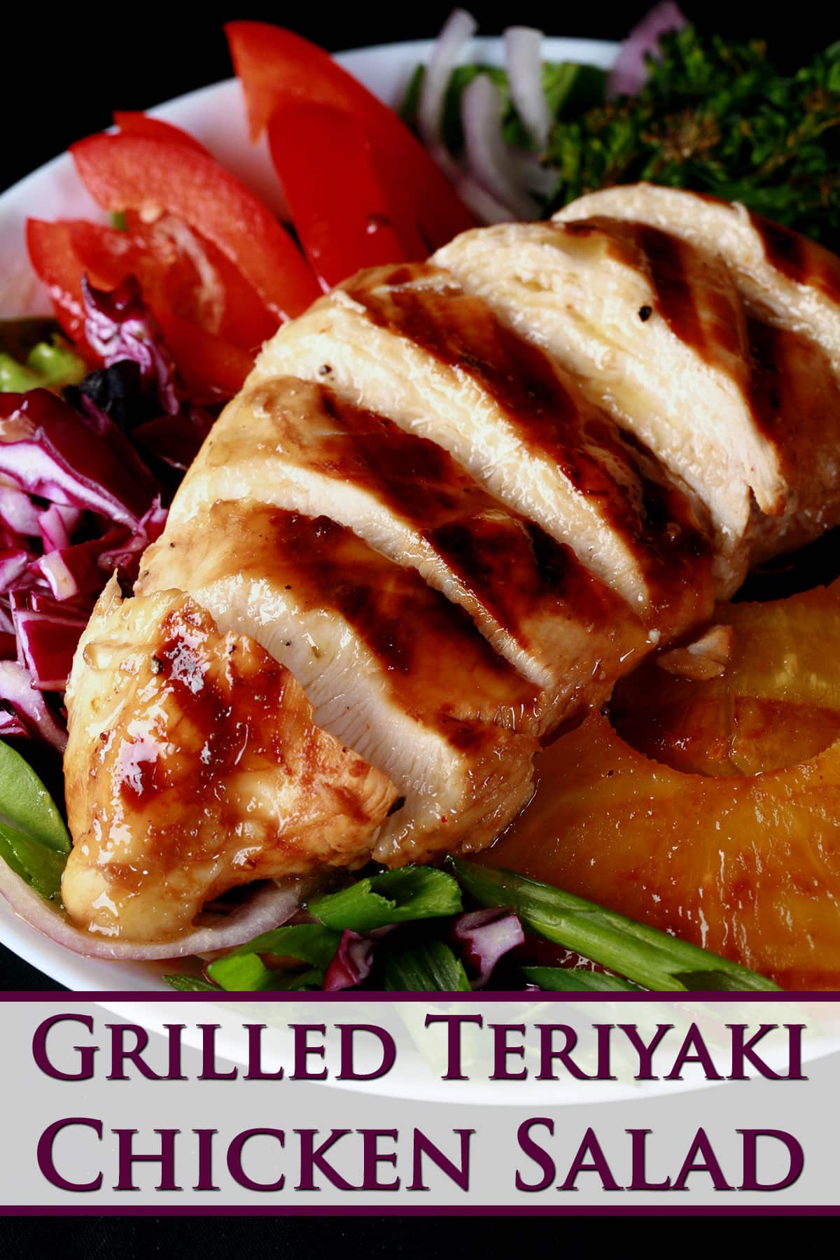 A grilled teriyaki chicken salad with fresh pineapple slices.